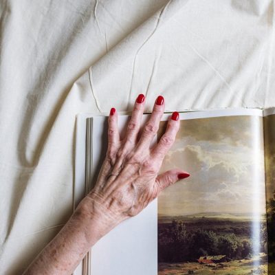 persons left hand with red manicure